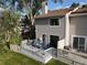 Townhome back exterior with a cozy patio and lush greenery at 12183 W Chenango Dr, Morrison, CO 80465