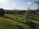 Overhead view of a grassy backyard and neighborhood in the distance at 12183 W Chenango Dr, Morrison, CO 80465