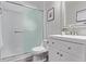 Modern bathroom with white vanity, stylish mirror, and a shower with a glass sliding door at 12183 W Chenango Dr, Morrison, CO 80465