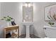Modern half bathroom with pedestal sink, updated fixtures, and contemporary decor for the perfect space at 12183 W Chenango Dr, Morrison, CO 80465