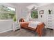 This updated bedroom boasts neutral walls, a window, and vinyl wood flooring and updated lighting at 12183 W Chenango Dr, Morrison, CO 80465