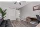 Cozy bedroom, equipped with a comfortable couch, ample closet space, a desk area, and wood-look flooring at 12183 W Chenango Dr, Morrison, CO 80465