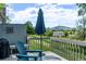 Beautiful deck area with mountain views, a blue umbrella, and wooden chair at 12183 W Chenango Dr, Morrison, CO 80465