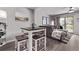 Eat-in kitchen area with dining table, with a living room and sliding glass doors in the background at 12183 W Chenango Dr, Morrison, CO 80465