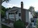 Multi-level house shows detailed exterior with brick accent, wood siding and deck with fence and chimney at 12183 W Chenango Dr, Morrison, CO 80465