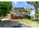 Inviting home exterior showcasing a lush yard and attached garage at 12183 W Chenango Dr, Morrison, CO 80465