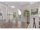 Bright hallway with hardwood floors, white trim and railings, and a door leading to a balcony at 12183 W Chenango Dr, Morrison, CO 80465