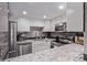 Kitchen featuring stainless steel appliances, granite countertops, and sleek grey backsplash at 12183 W Chenango Dr, Morrison, CO 80465