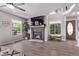 Bright living room features a brick fireplace, large windows and neutral paint colors at 12183 W Chenango Dr, Morrison, CO 80465