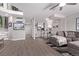 Spacious living room with modern flooring, gray sectional sofa, and staircase to upper level at 12183 W Chenango Dr, Morrison, CO 80465