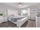 The primary bedroom features hardwood floors, neutral walls, a ceiling fan, and an abundance of natural light at 12183 W Chenango Dr, Morrison, CO 80465