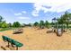 Community playground featuring slides, swings, and climbing structures in a sunny, Gathering-friendly environment at 12183 W Chenango Dr, Morrison, CO 80465