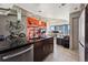 Modern kitchen with stainless steel appliances and red island at 891 14Th St # 2816, Denver, CO 80202