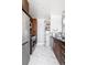 Well-lit kitchen featuring stainless steel appliances, dark wood cabinets, and elegant white marble floors at 891 14Th St # 2816, Denver, CO 80202