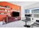 Bright living room offering city views, a dedicated workspace, and an entertainment center with shelving at 891 14Th St # 2816, Denver, CO 80202