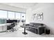 Living room offering comfortable seating, city views, and a well-lit workspace with sleek modern decor at 891 14Th St # 2816, Denver, CO 80202