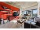 Living room with red accent wall, city views, and modern decor at 891 14Th St # 2816, Denver, CO 80202
