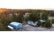 Spacious property with a large blue outbuilding, RV parking, and mature trees at 1059 S Elbert St, Elizabeth, CO 80107