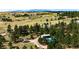 Expansive rural property showcasing diverse terrain, scattered homes, and distant mountain views at 1059 S Elbert St, Elizabeth, CO 80107