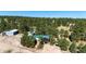 Aerial view of the property surrounded by lush green trees at 1059 S Elbert St, Elizabeth, CO 80107