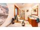 Bright bathroom featuring unique decor, a tub, and a shower with glass door at 1059 S Elbert St, Elizabeth, CO 80107