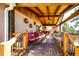 Relax on this spacious, covered deck featuring wood ceiling, ceiling fan, and plenty of seating at 1059 S Elbert St, Elizabeth, CO 80107