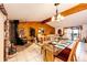 Cozy dining area with fireplace, wood accents, and access to the living room and backyard deck at 1059 S Elbert St, Elizabeth, CO 80107