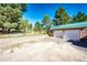 Spacious two-car garage with a neutral color scheme and well maintained exterior, nestled in a wooded area at 1059 S Elbert St, Elizabeth, CO 80107