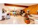 Open-concept living space with wood accents, fireplace, and access to the dining and kitchen areas at 1059 S Elbert St, Elizabeth, CO 80107