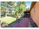 A red brick patio overlooks a grassy yard and mature trees, offering privacy and space at 1059 S Elbert St, Elizabeth, CO 80107
