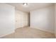 Bedroom featuring two white doors, neutral colors, and carpet floors at 15716 E Temple Pl, Aurora, CO 80015