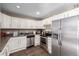 Modern kitchen featuring white cabinetry and stainless steel appliances at 15716 E Temple Pl, Aurora, CO 80015