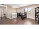 Upstairs loft area with wood floors, a pendant light, a work space, and a window with a view at 15716 E Temple Pl, Aurora, CO 80015