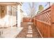 Small backyard with stone path and wood fence at 150 S Madison St # 112, Denver, CO 80209