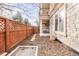 Small backyard with stone path and wood fence at 150 S Madison St # 112, Denver, CO 80209