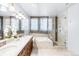 Spa-like bathroom with double vanity, walk-in shower, and soaking tub at 150 S Madison St # 112, Denver, CO 80209