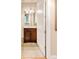 Clean bathroom with a dark wood vanity and tile floor at 150 S Madison St # 112, Denver, CO 80209