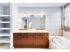 Bathroom with double vanity, and soaking tub at 150 S Madison St # 112, Denver, CO 80209