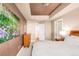 Bright bedroom with a dresser, large artwork, and access to bathroom at 150 S Madison St # 112, Denver, CO 80209