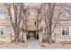 Attractive building entrance with stone facade and gated entry at 150 S Madison St # 112, Denver, CO 80209