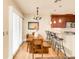 Bright dining area features a wood table with bench seating and a view to the kitchen at 150 S Madison St # 112, Denver, CO 80209