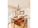 Light-filled dining area with wood table, bench, and access to patio at 150 S Madison St # 112, Denver, CO 80209
