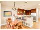 Open kitchen with granite countertops, stainless steel appliances, and breakfast bar at 150 S Madison St # 112, Denver, CO 80209