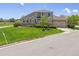 Charming two-story home with lush front lawn, mature landscaping, and a two-car garage at 22455 E Plymouth Cir, Aurora, CO 80016