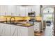Modern kitchen with sleek countertops, stainless steel appliances, and white cabinets at 22455 E Plymouth Cir, Aurora, CO 80016