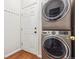 Modern laundry room with stacked washer and dryer and ample space at 22455 E Plymouth Cir, Aurora, CO 80016