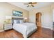 Comfortable main bedroom featuring hardwood floors, and an ensuite bathroom with a soaking tub at 22455 E Plymouth Cir, Aurora, CO 80016