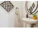 Stylish powder room with modern sink and decorative mirror at 22455 E Plymouth Cir, Aurora, CO 80016