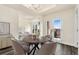 Elegant dining room with chandelier, seating for four, and a balcony with city views at 1827 N Grant St # 604, Denver, CO 80203