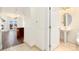 Hallway view towards an open floor plan with a partial kitchen and a bathroom featuring a pedestal sink at 1827 N Grant St # 604, Denver, CO 80203
